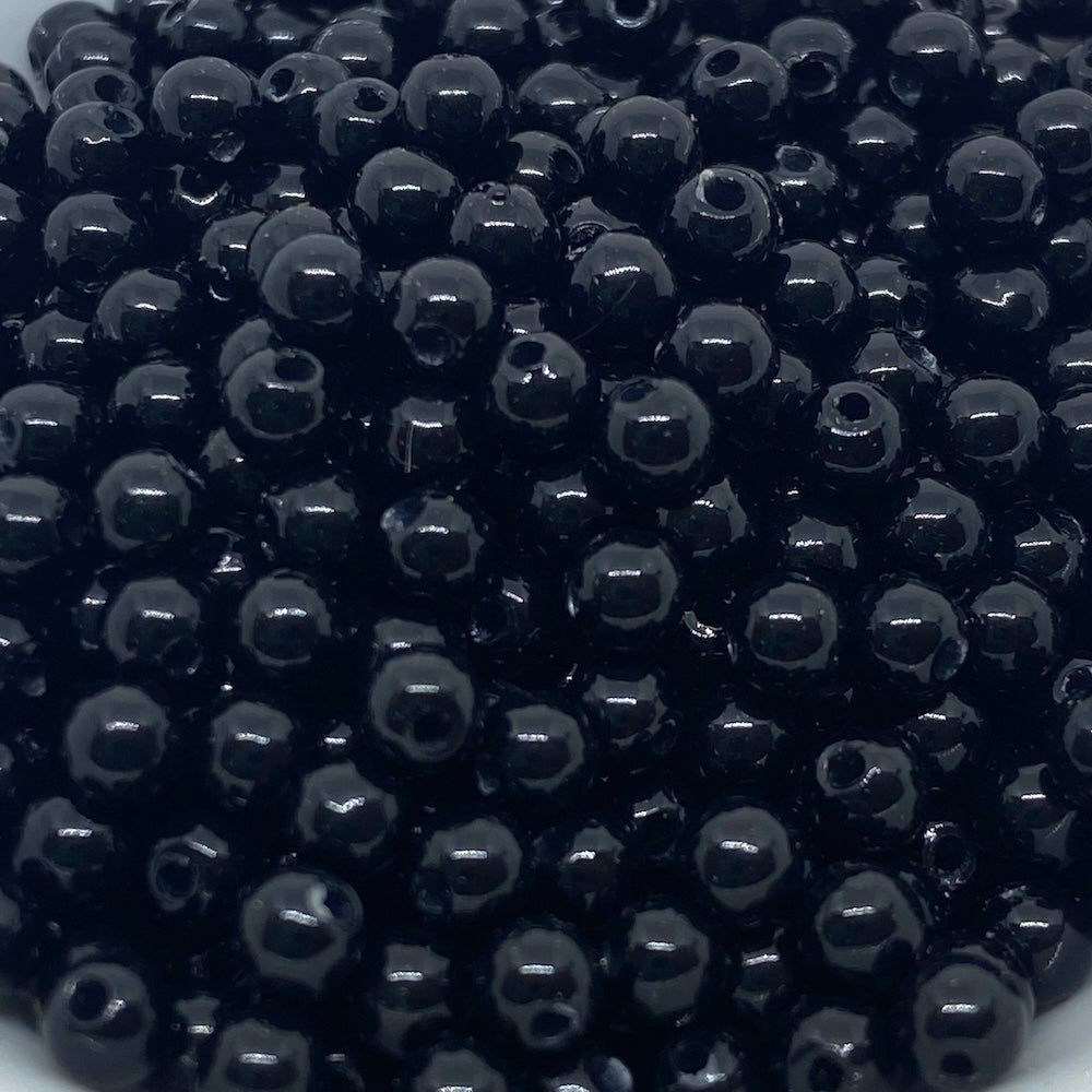 Close-up of black beads on a white background