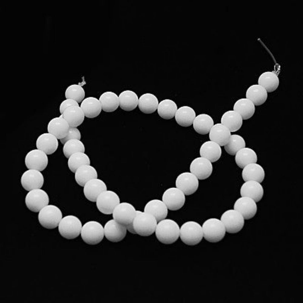 White beads on a black background