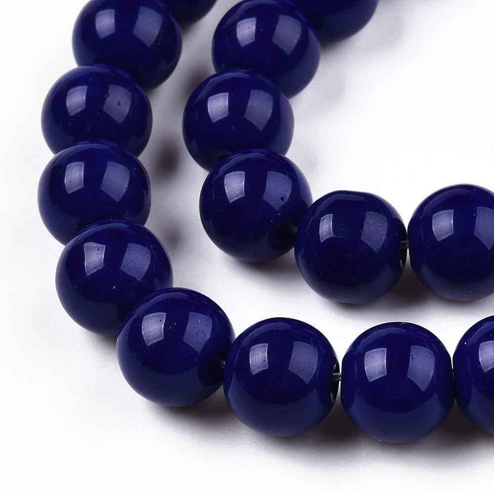 Close-up of a string of dark blue beads on a white background