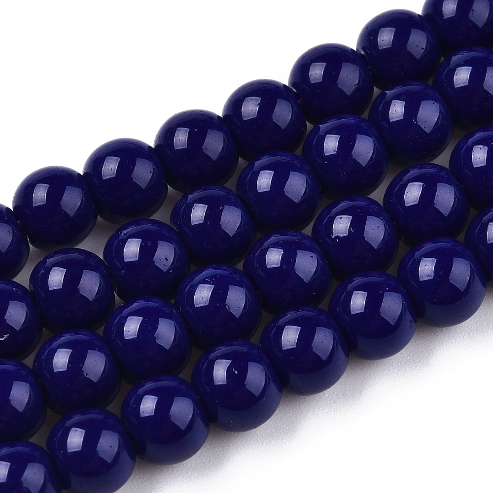 Close-up of dark blue beads on a white background
