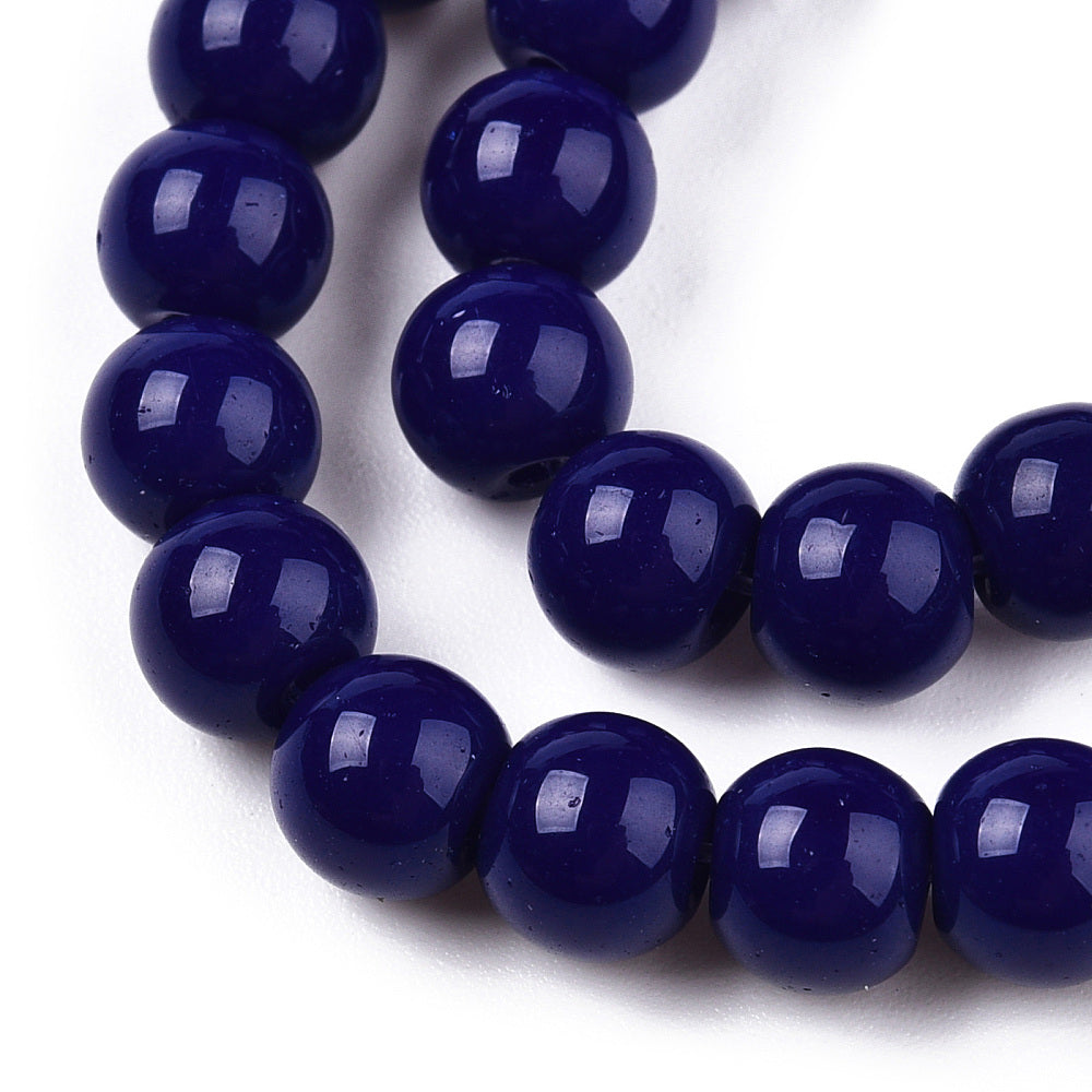 Close-up of a string of dark blue beads on a white background