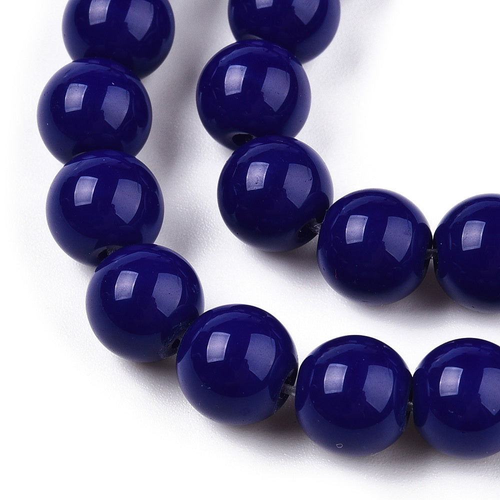 Close-up of a string of dark blue beads on a white background