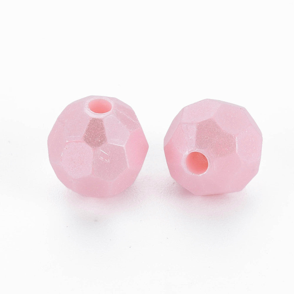 Two faceted pink glass beads with a single central hole, displayed on a clean white background.