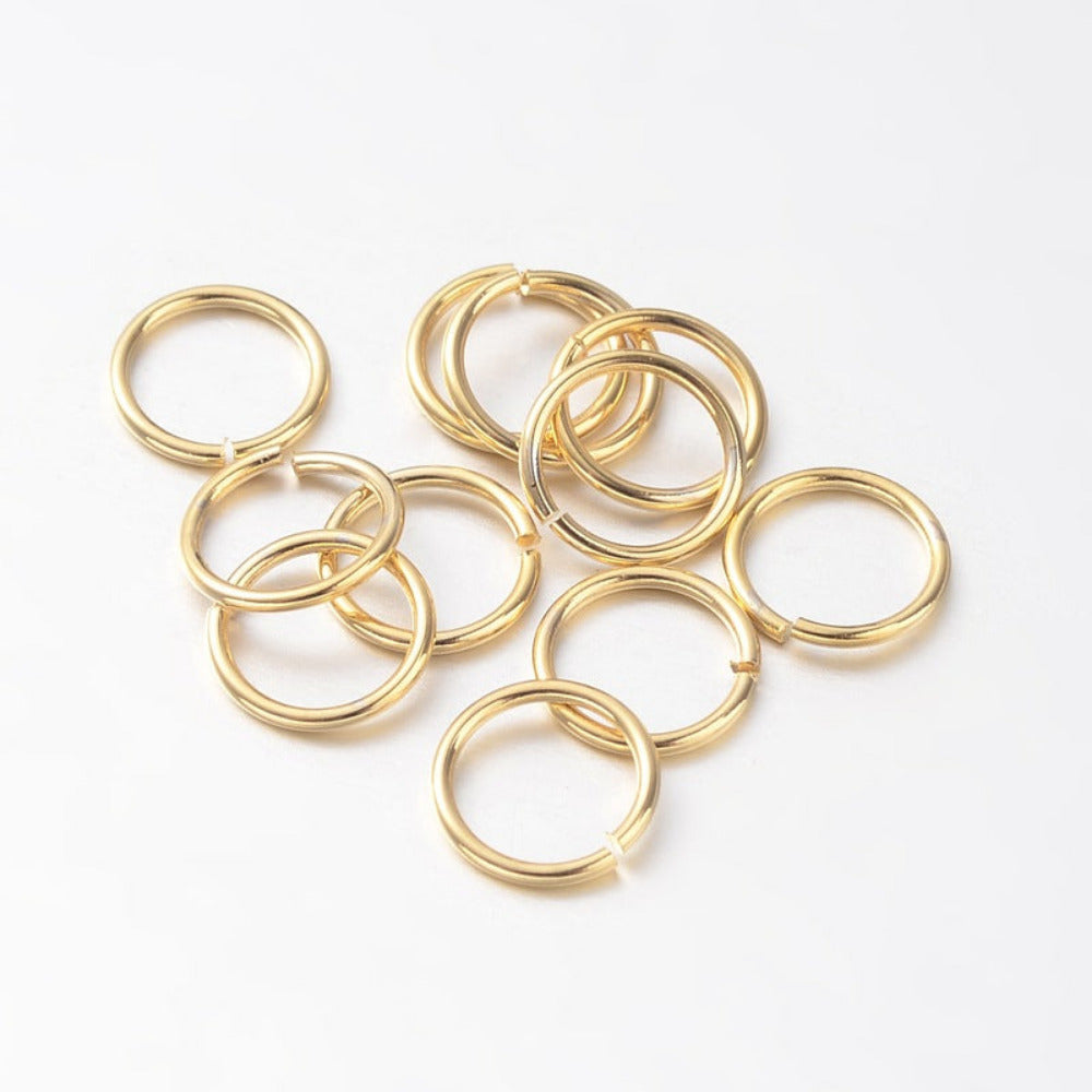 small metal joining jump rings to connect jewelry and craft items with anti tarnish surface on a white background