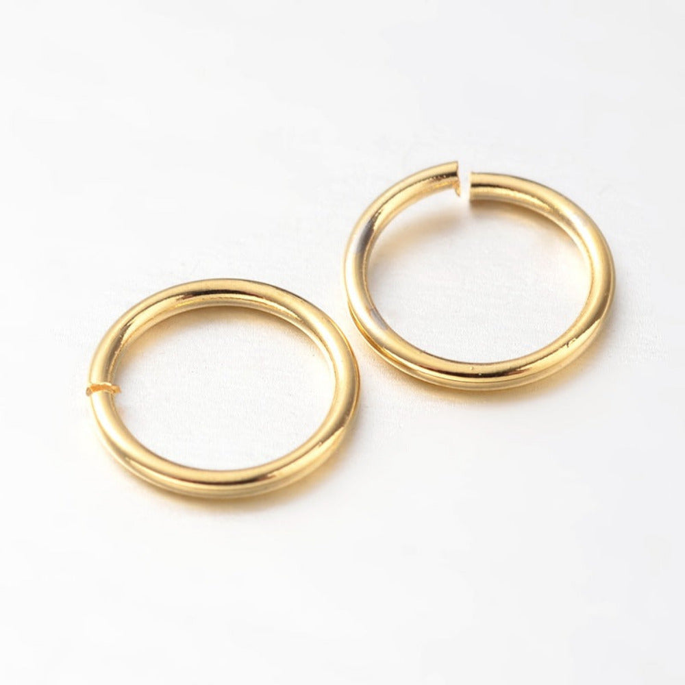 two small metal joining jump rings to connect jewelry and craft items with anti tarnish surface on a white background