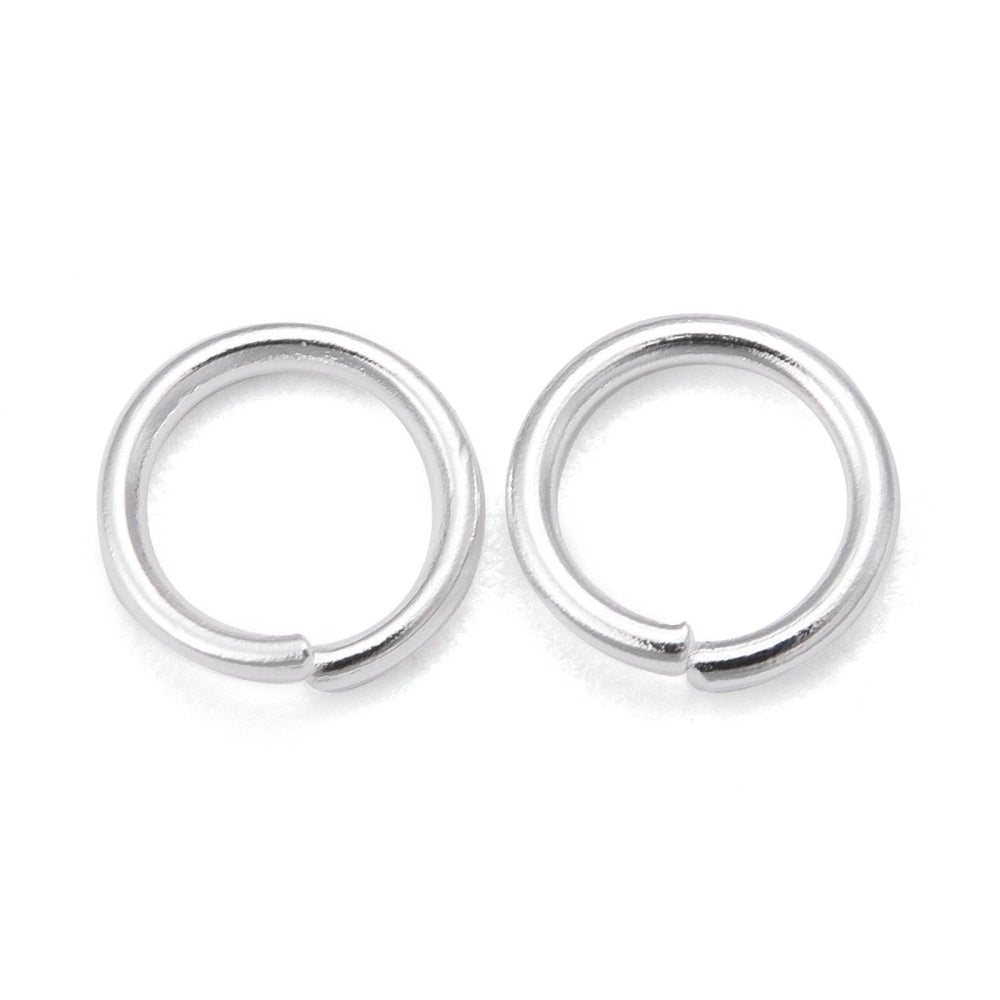 Two silver connector rings on a white background