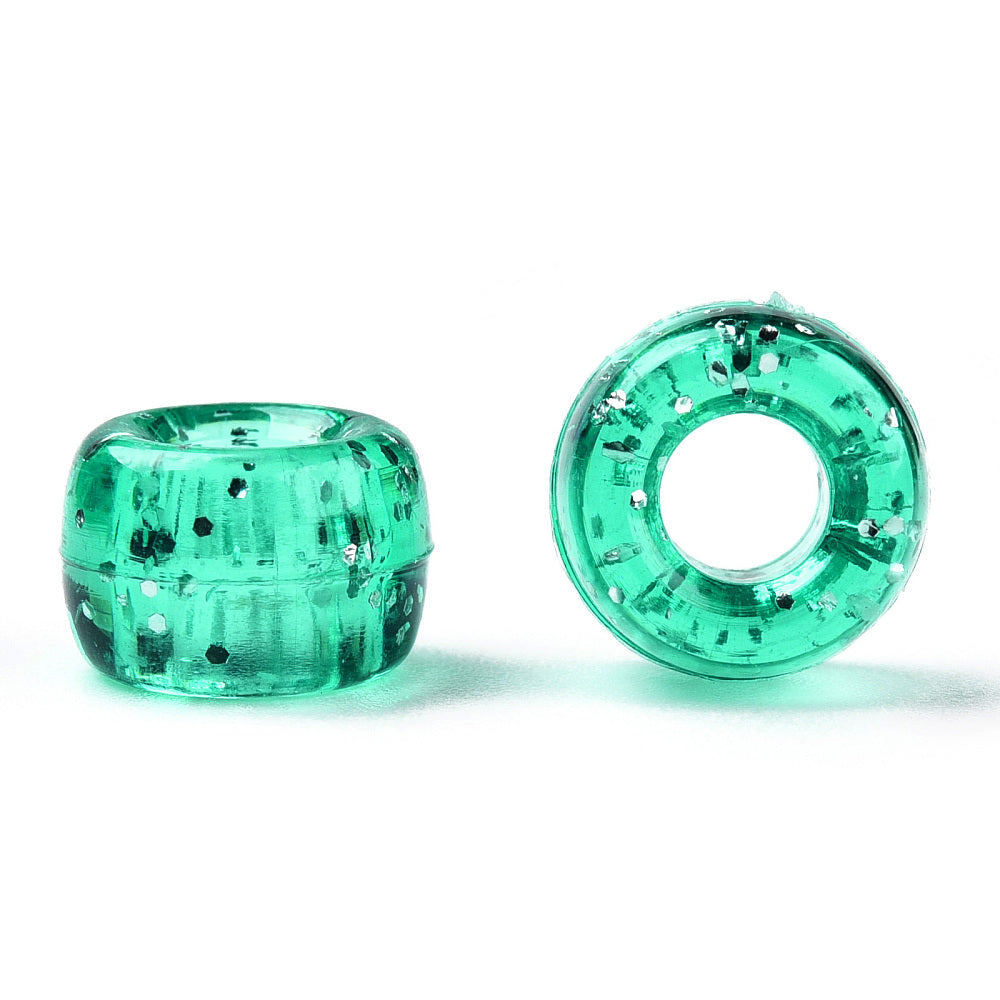 A close-up image of green teal glitter transparent acrylic pony beads with a visible hole in the center for stringing purposes.