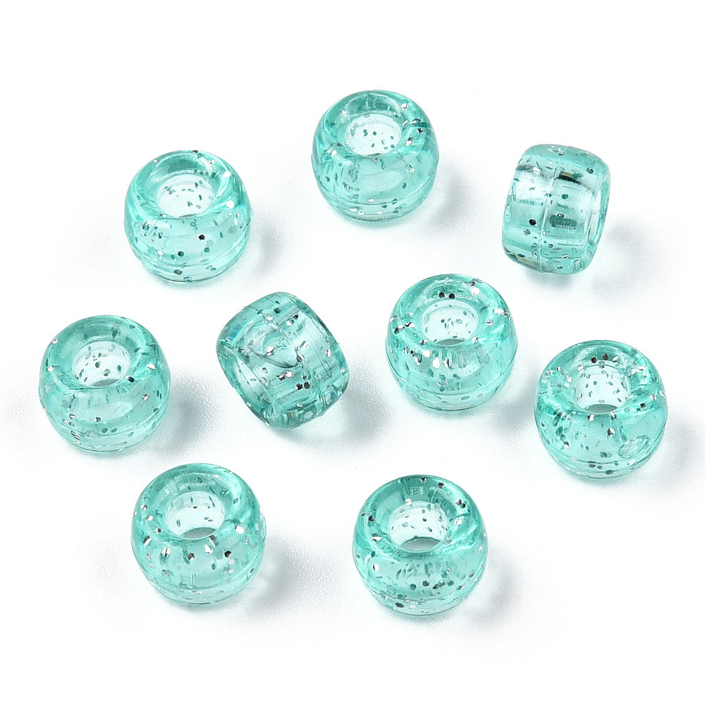 A close-up image of light teal glitter transparent acrylic pony beads with a visible hole in the center for stringing purposes.