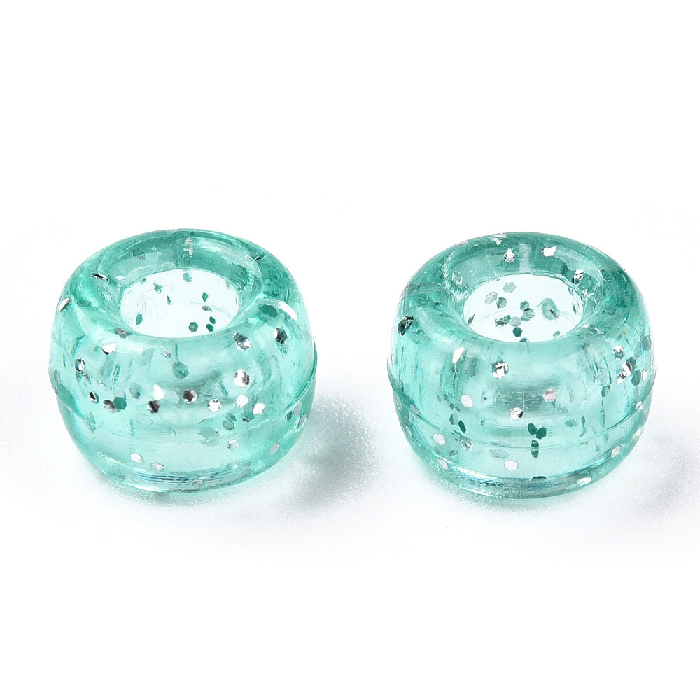 A close-up image of light teal glitter transparent acrylic pony beads with a visible hole in the center for stringing purposes.