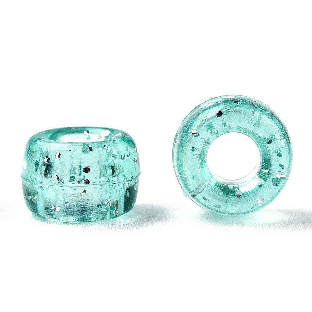 A close-up image of light teal glitter transparent acrylic pony beads with a visible hole in the center for stringing purposes.