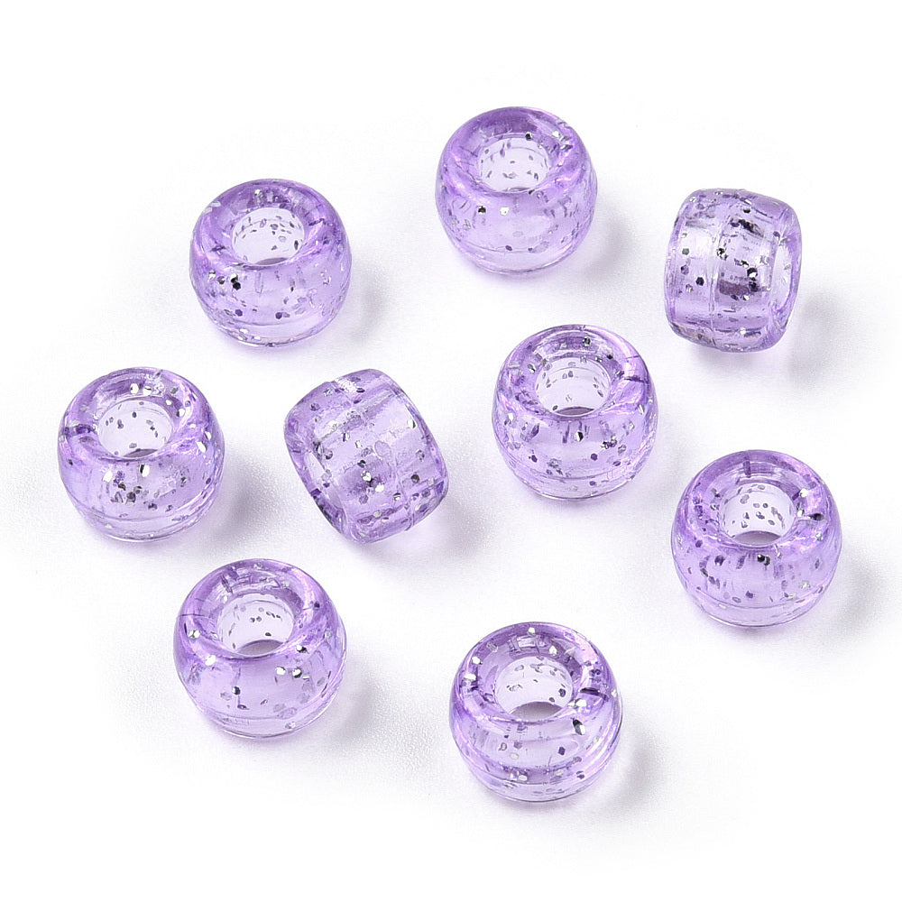 A close-up image of light purple glitter transparent acrylic pony beads with a visible hole in the center for stringing purposes.