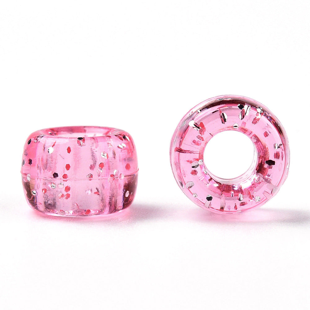 A pair of pink glittery acrylic pony beads with a large hole, displayed on a white background.