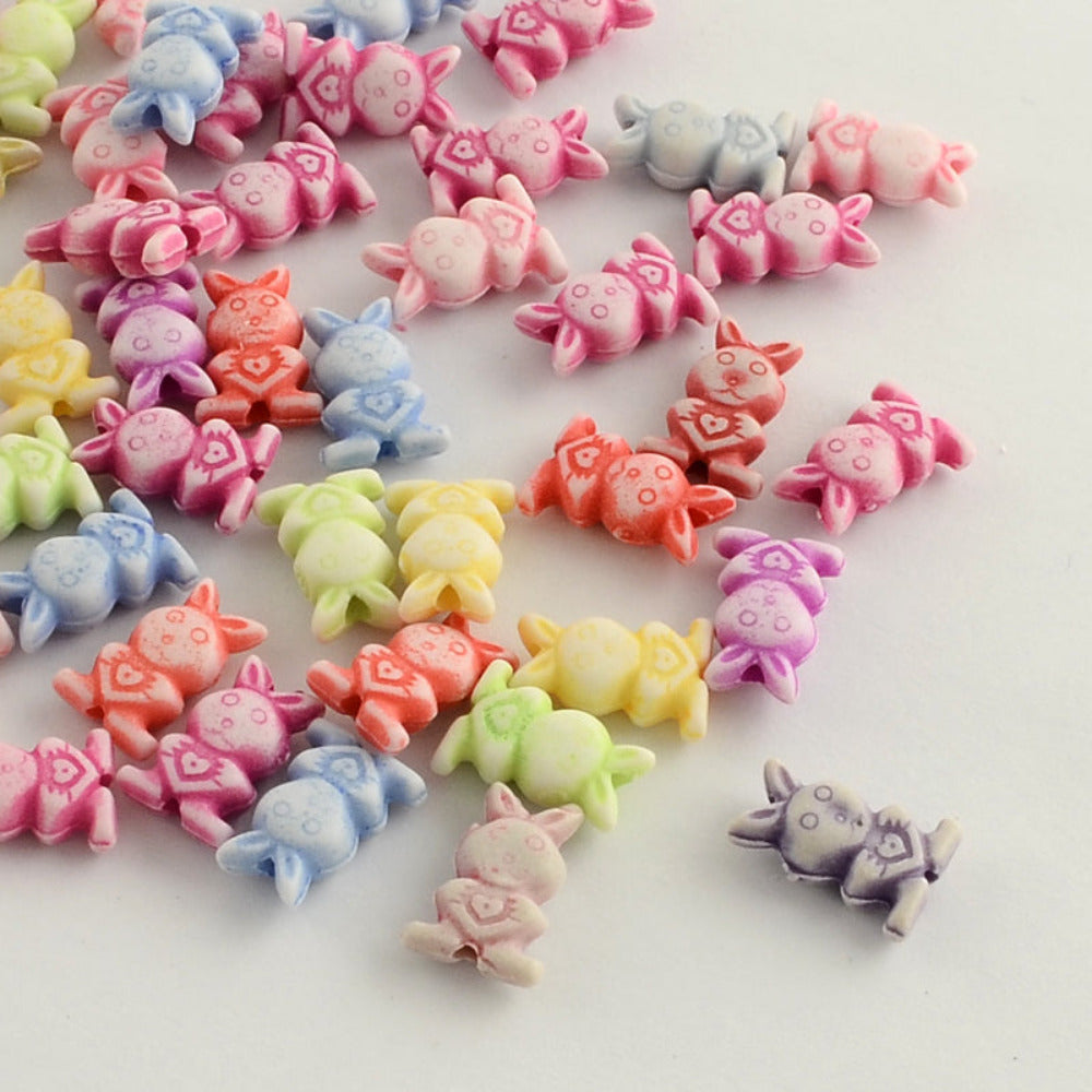 Colorful rabbit-shaped beads on a white background