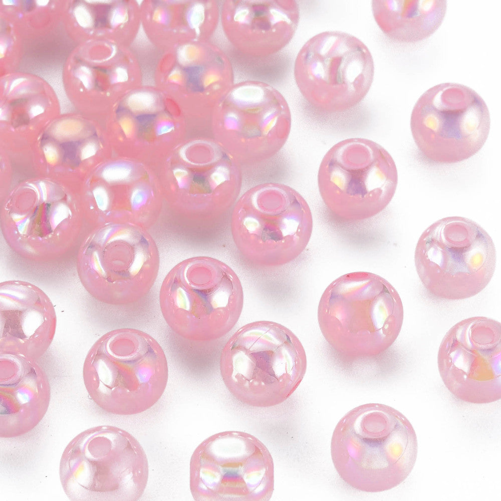 A collection of round pink acrylic beads with a slight metallic sheen, intended for crafting and jewelry making.