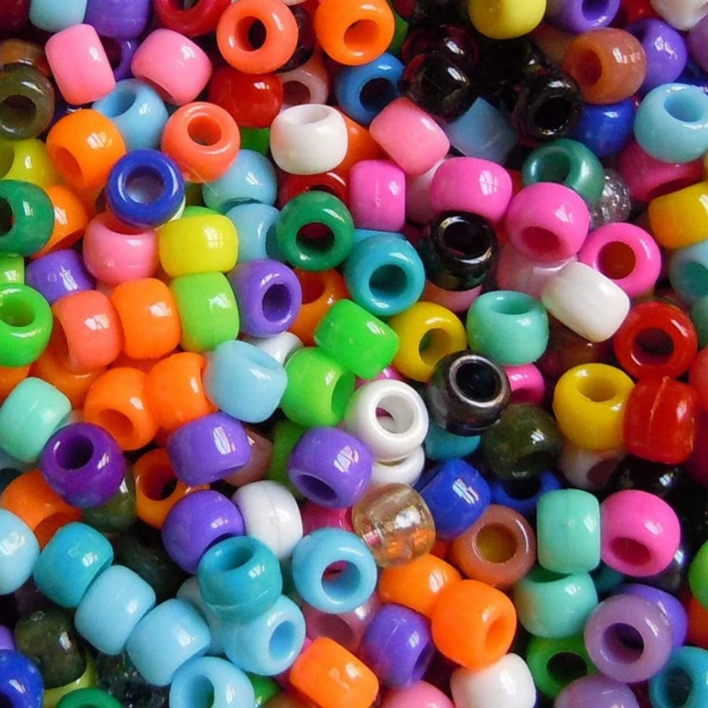 Assorted colorful plastic beads in various colors.