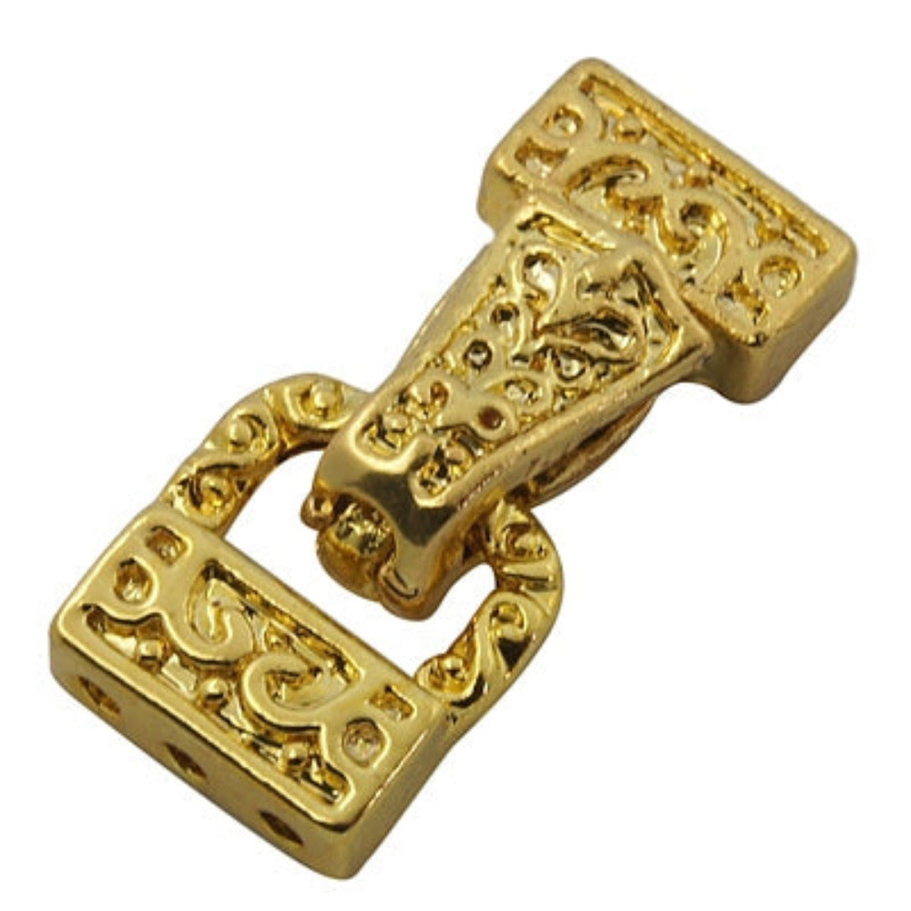 Gold decorative buckle clasp on a white background