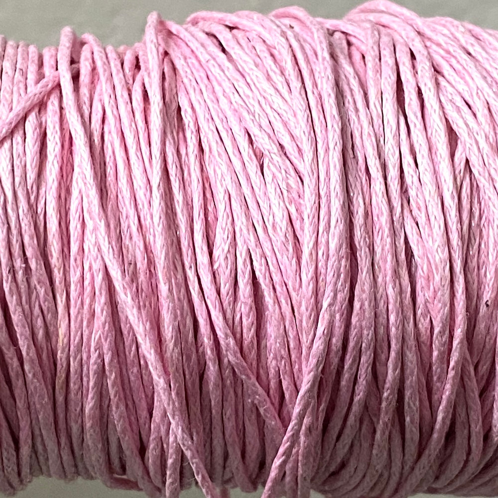 Close-up of pink wax cotton strands