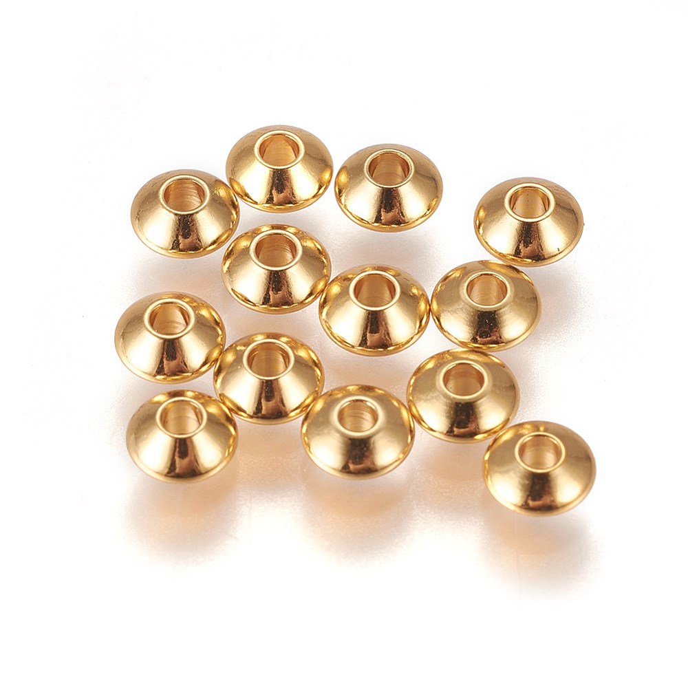 Gold beads on a white background