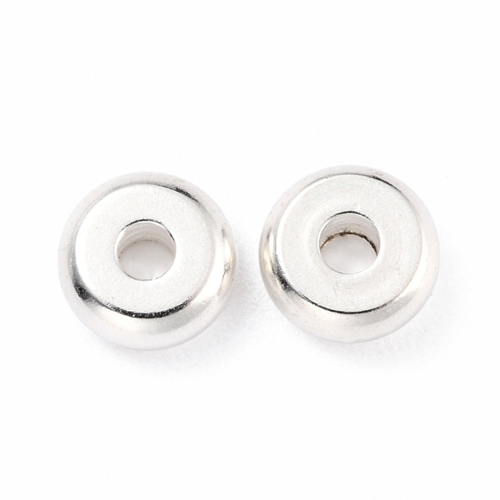 Two silver beads on a white background