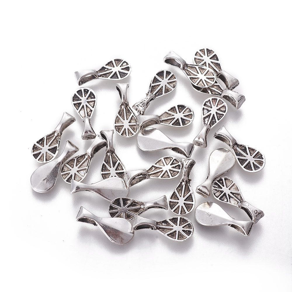 tibetan look metal oval bails with patterning for the glue to hold on a white background