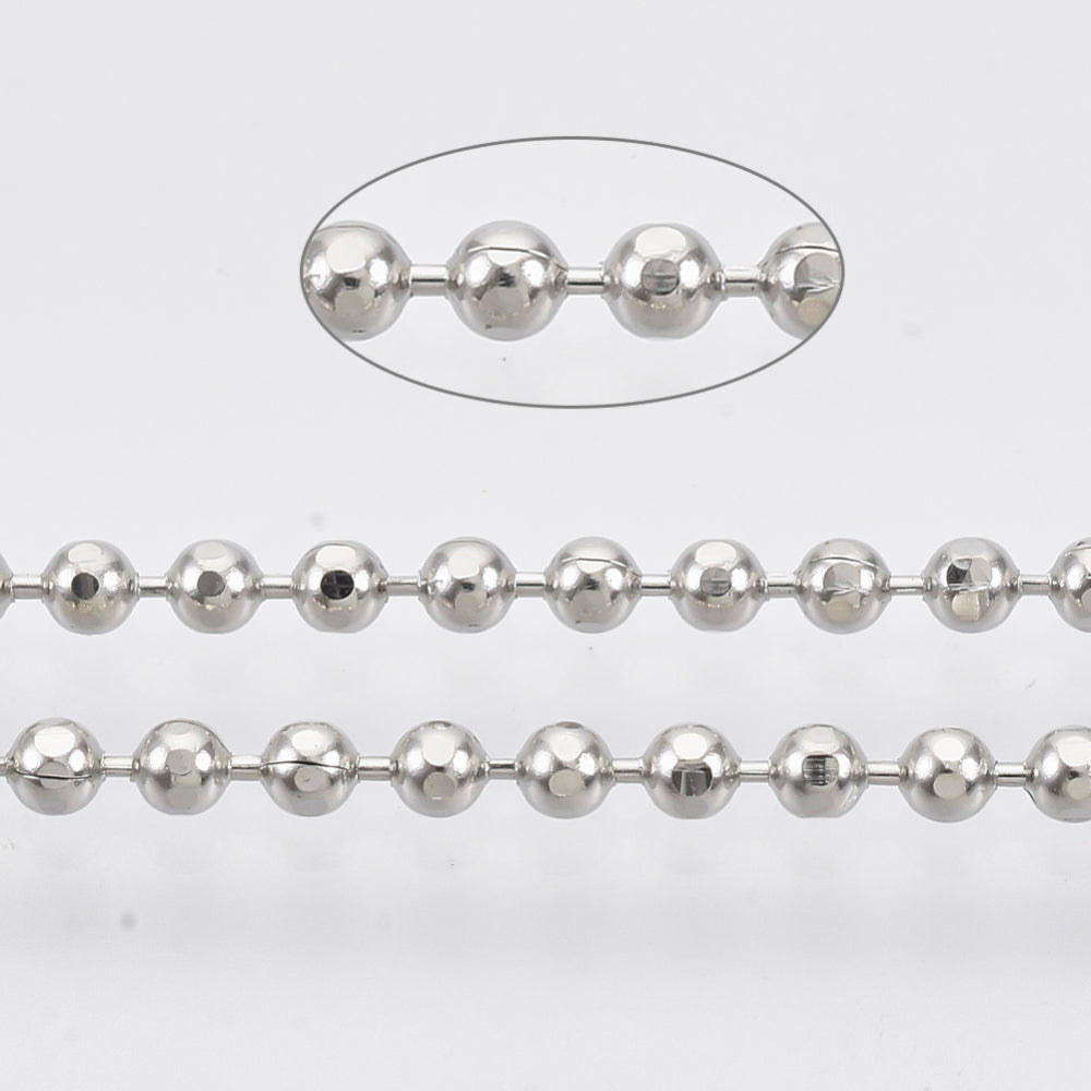 A roll of ball chain with metal balls linked together, along with a close-up view showing the texture and size of the balls.