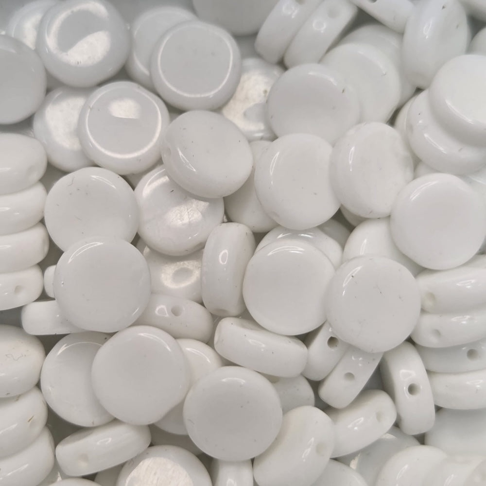 Close-up of white flat round beads with a glossy finish.