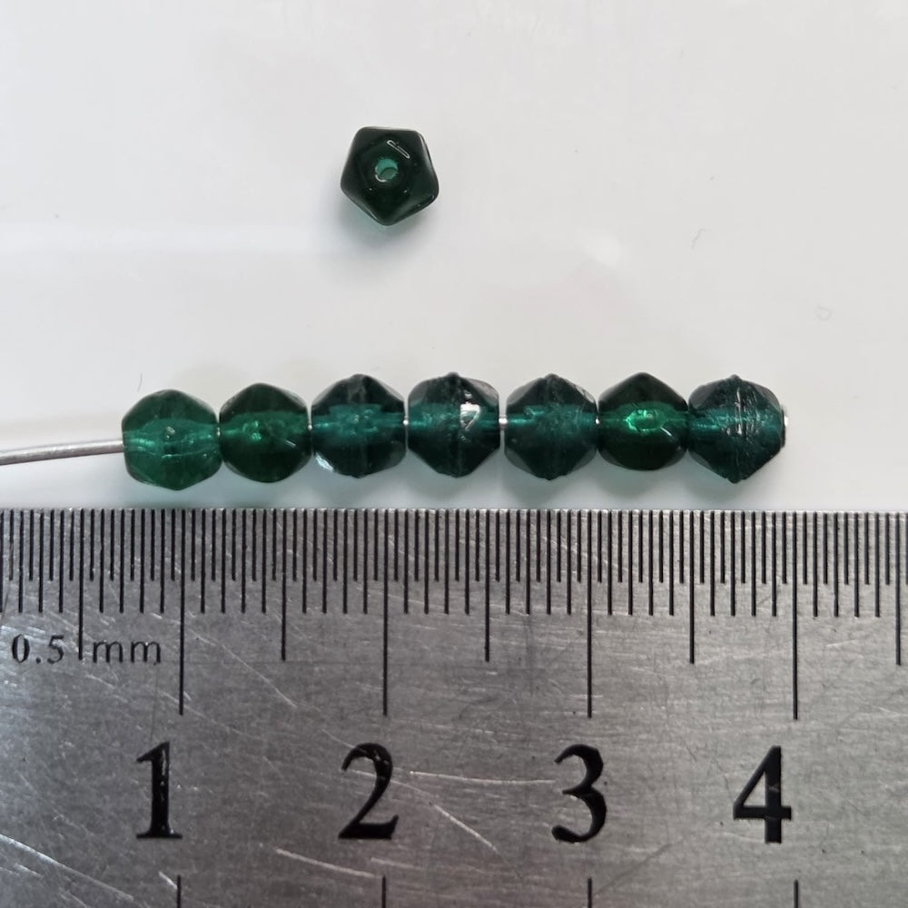 Green beads on a ruler for size reference