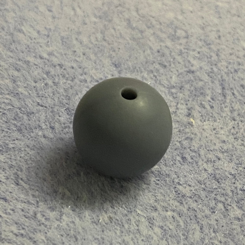 gray silicone bead on a gray textured surface