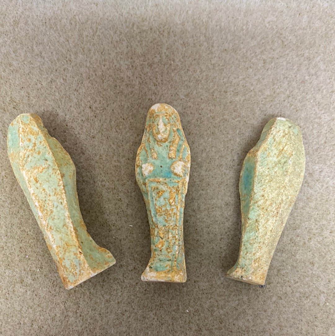 Three vintage Egyptian faience amulet beads with blue and green colors, showing human-like figures one front on and two reversed to show the backs