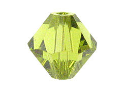 Faceted yellow-green crystal bead on a white background