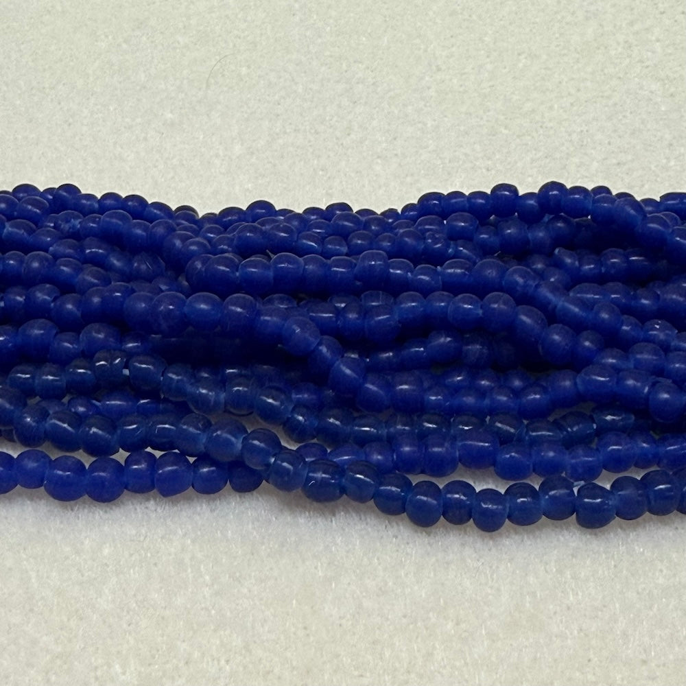 Strings of blue round beads on a light gray background