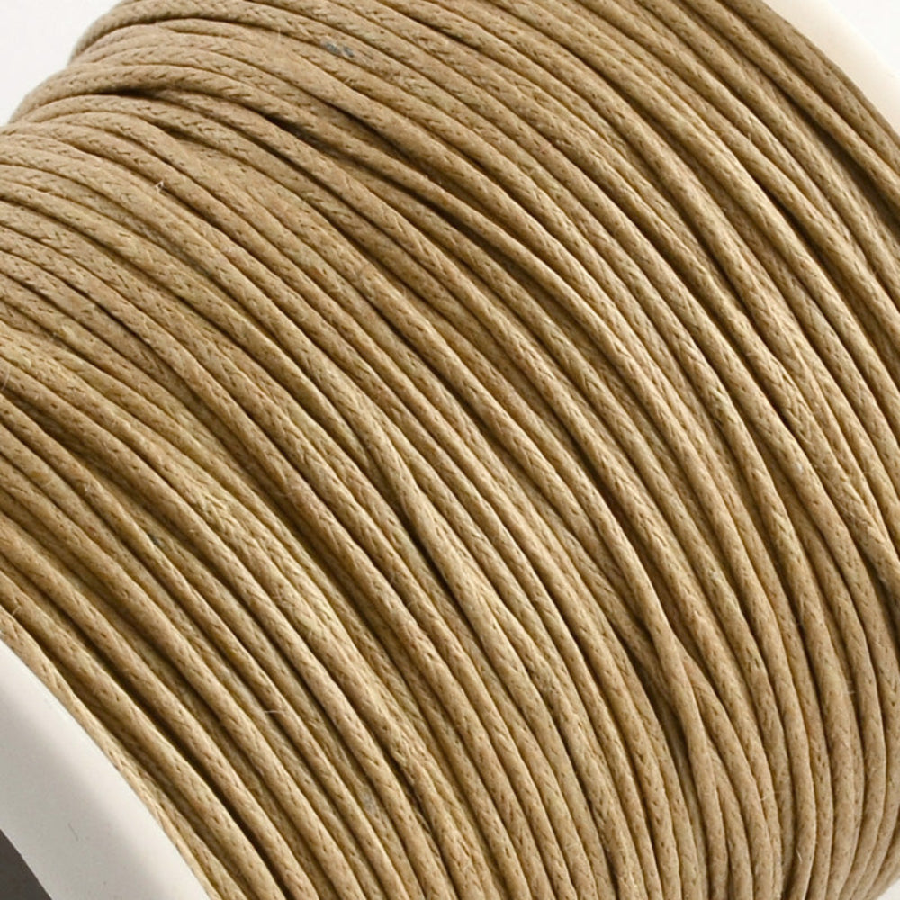 A spool of natural colour wax cotton cord used for crafting and jewelry making.