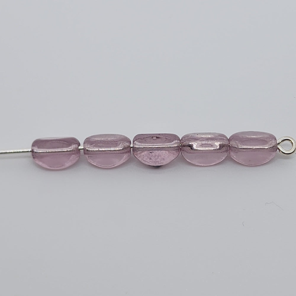 pinched rice light purple beads on a pin with a white background