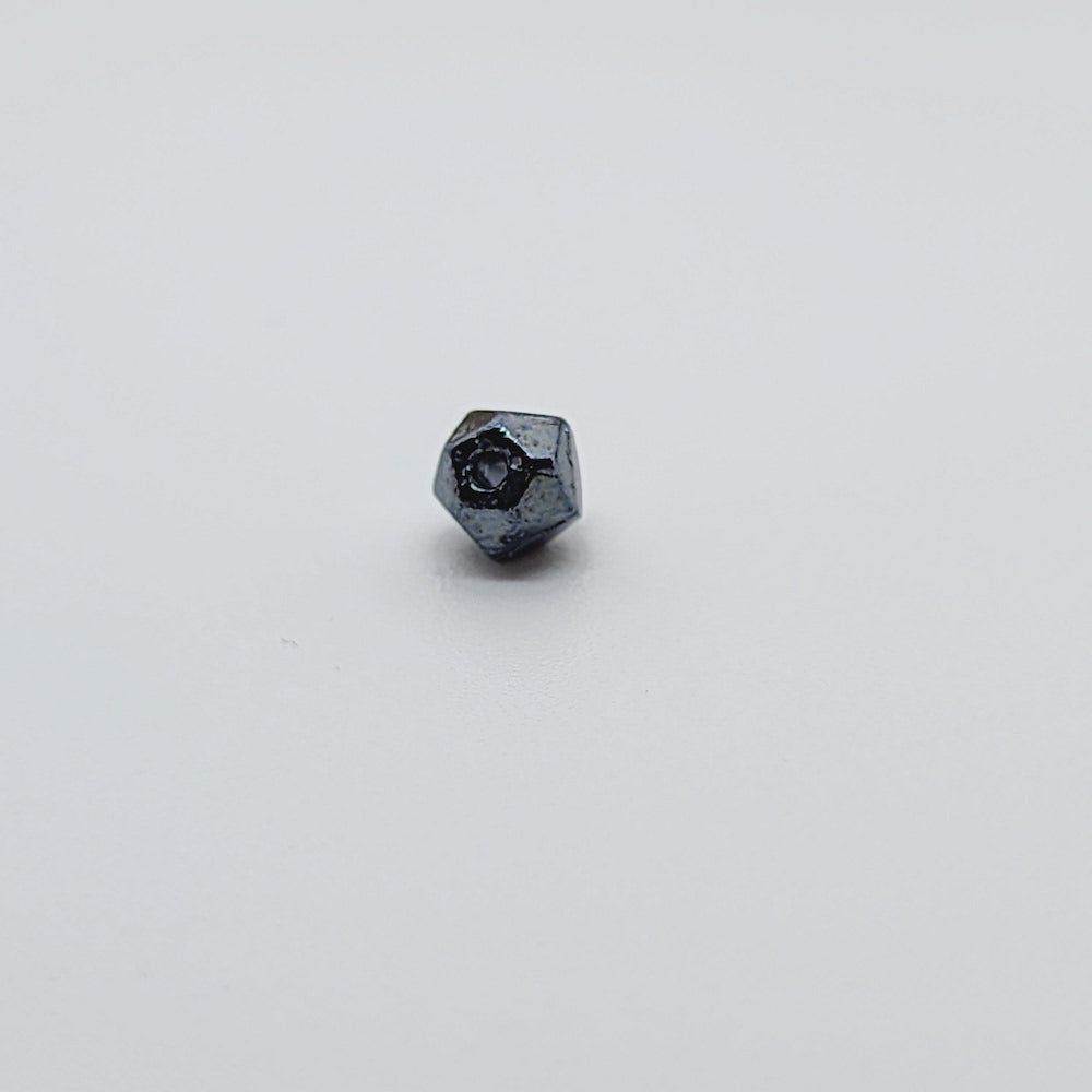 one gunmetal grey facet bead on white background