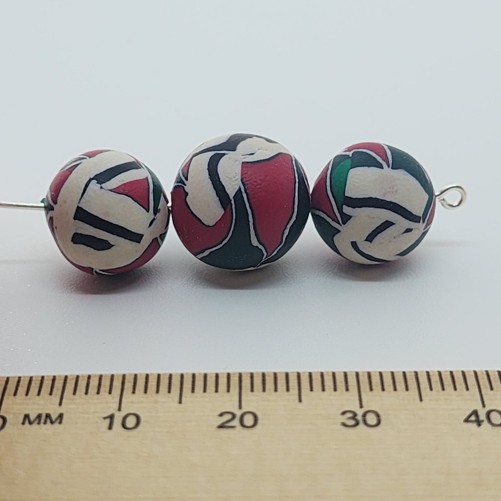 12mm Round Fimo Beads (10) - Red/Green Interlocking Triangles