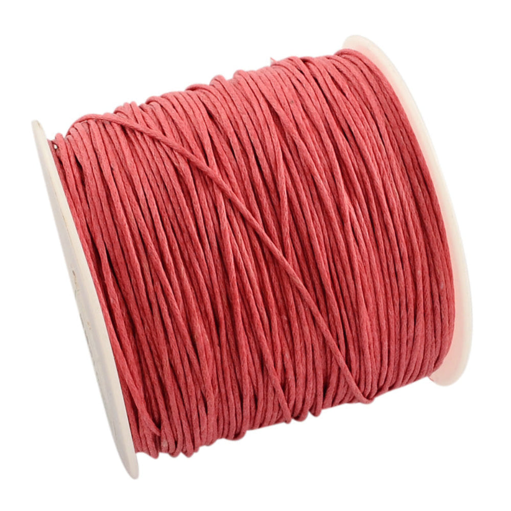 A spool of light coral wax cotton cord for crafting.