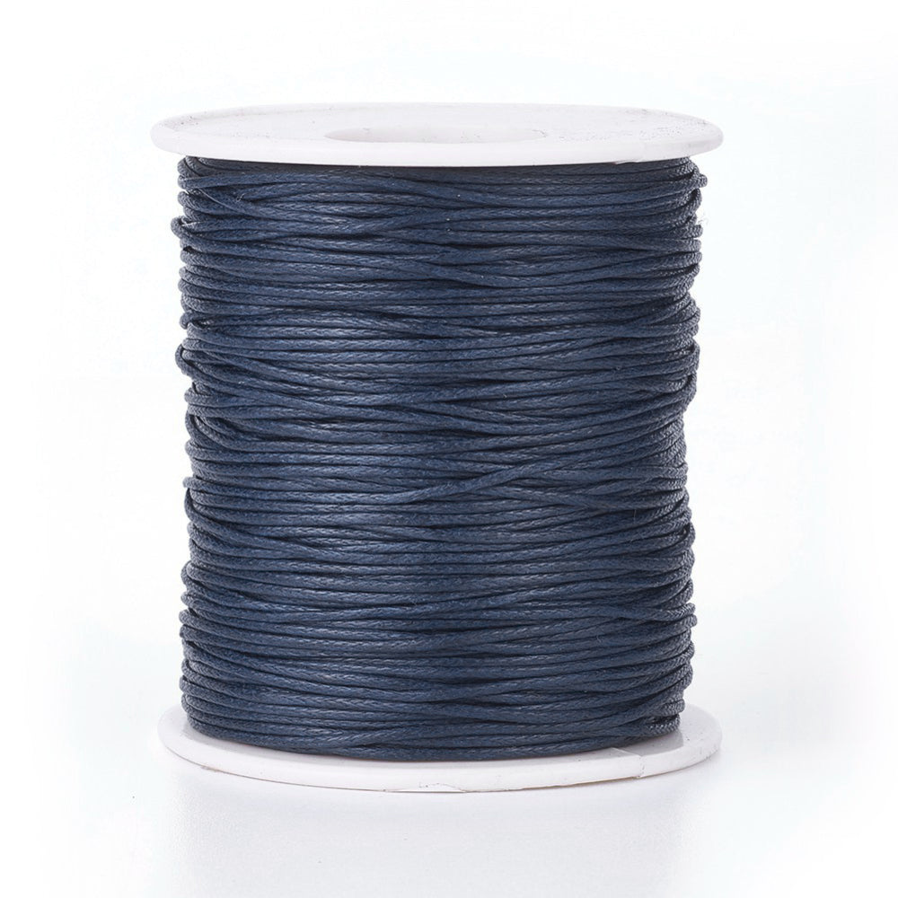 A spool of prussian blue wax cotton cord for crafting purposes.