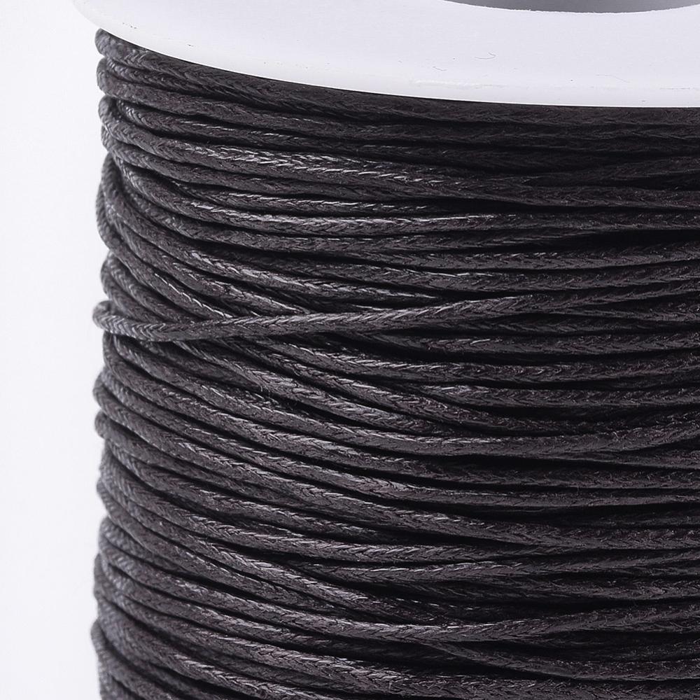 A spool of waxed cotton cord in brown color for crafting and jewelry making.