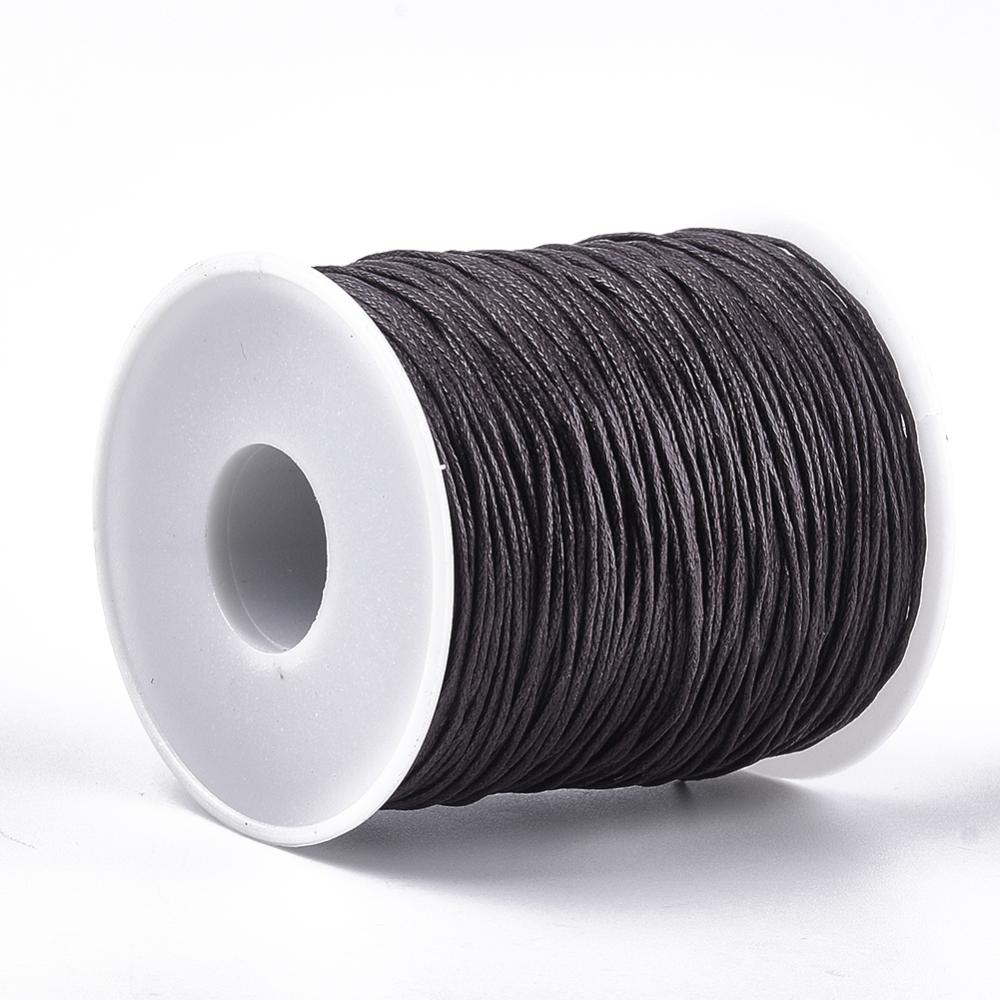 A spool of waxed cotton cord in brown color for crafting and jewelry making.