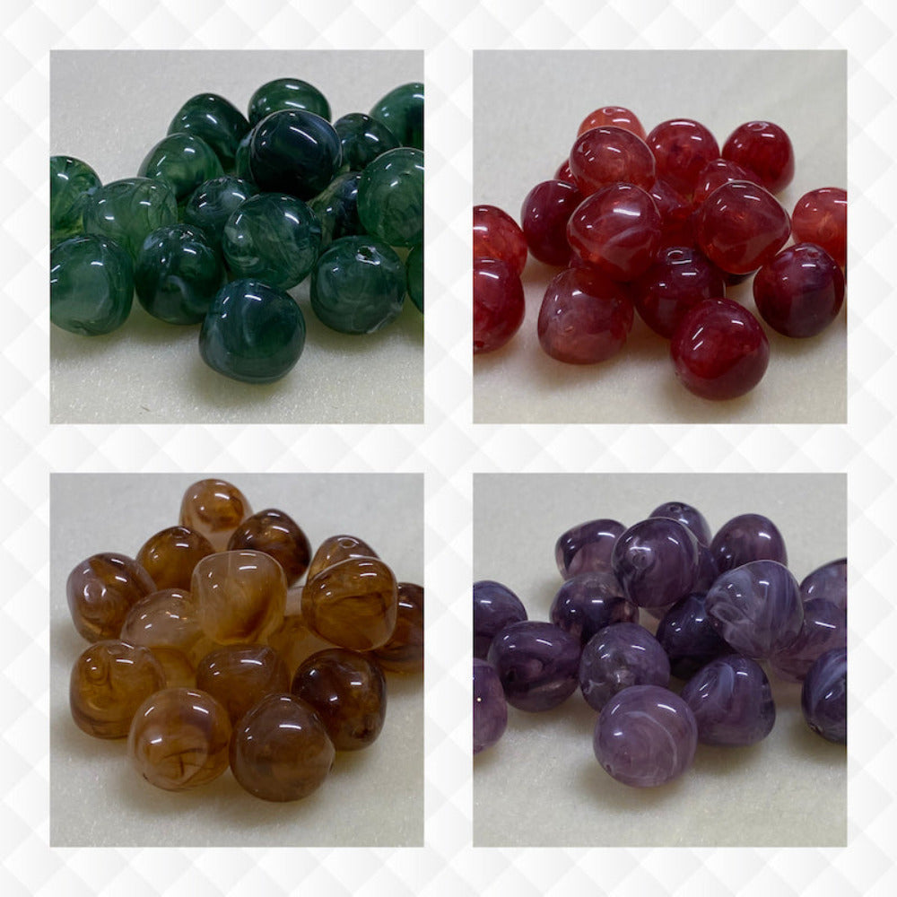 A collage of four different colours of the same style bead in small groups on a cream background