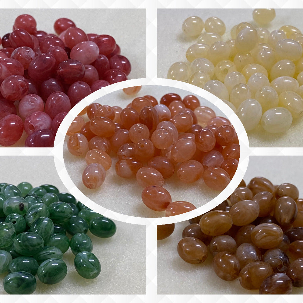 A collage of five different colours of the same gemstone look style bead in small groups on a cream background