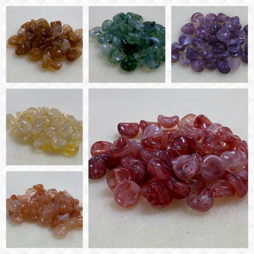 A collage of six different colours of the same gemstone look style bead in small groups on a cream background