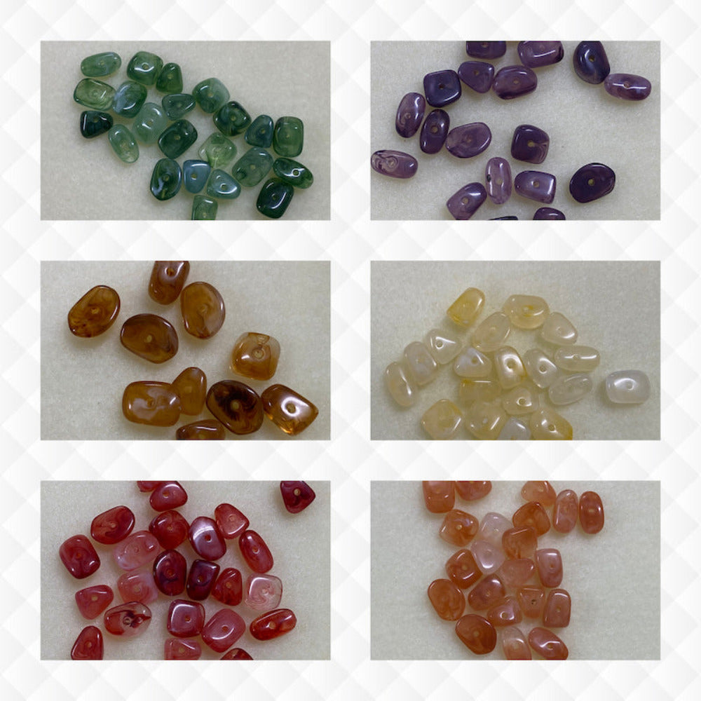A collage of six different colours of the same gemstone look style bead in small groups on a cream background