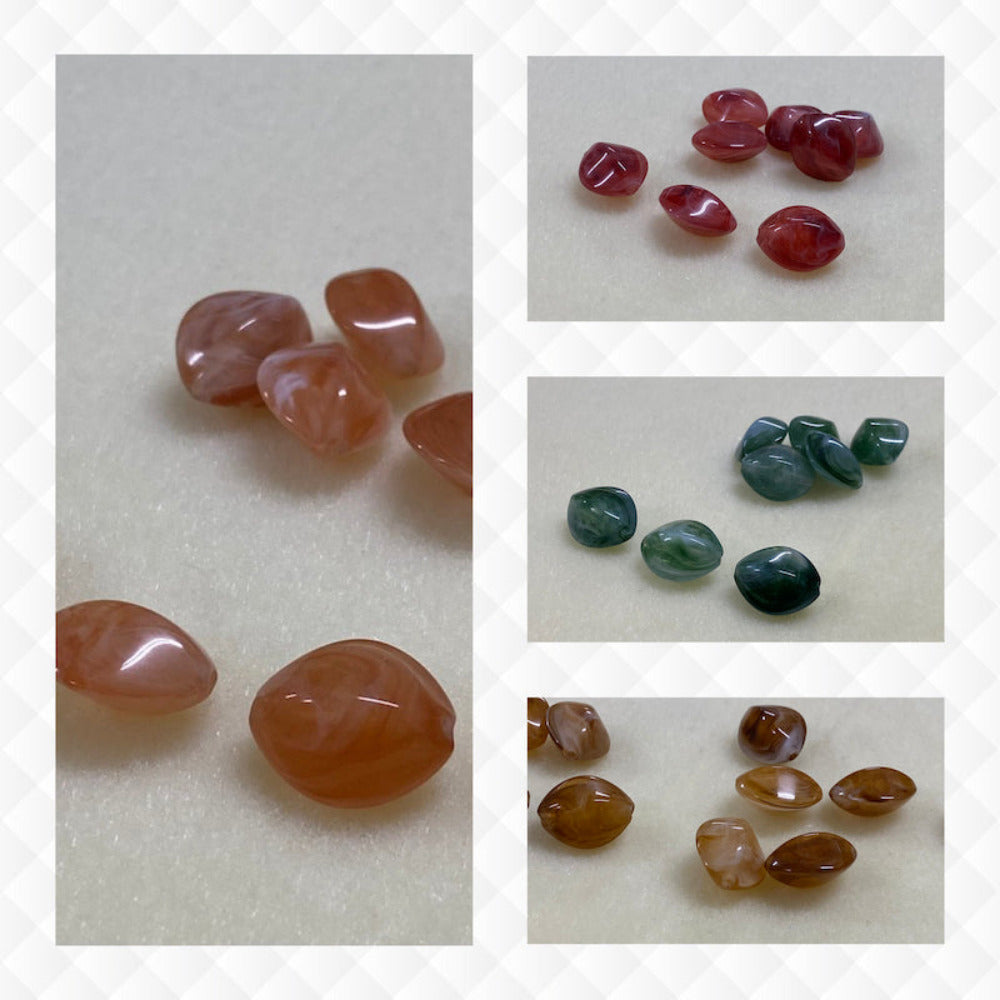 A collage of four different colours of the same gemstone look style bead in small groups on a cream background