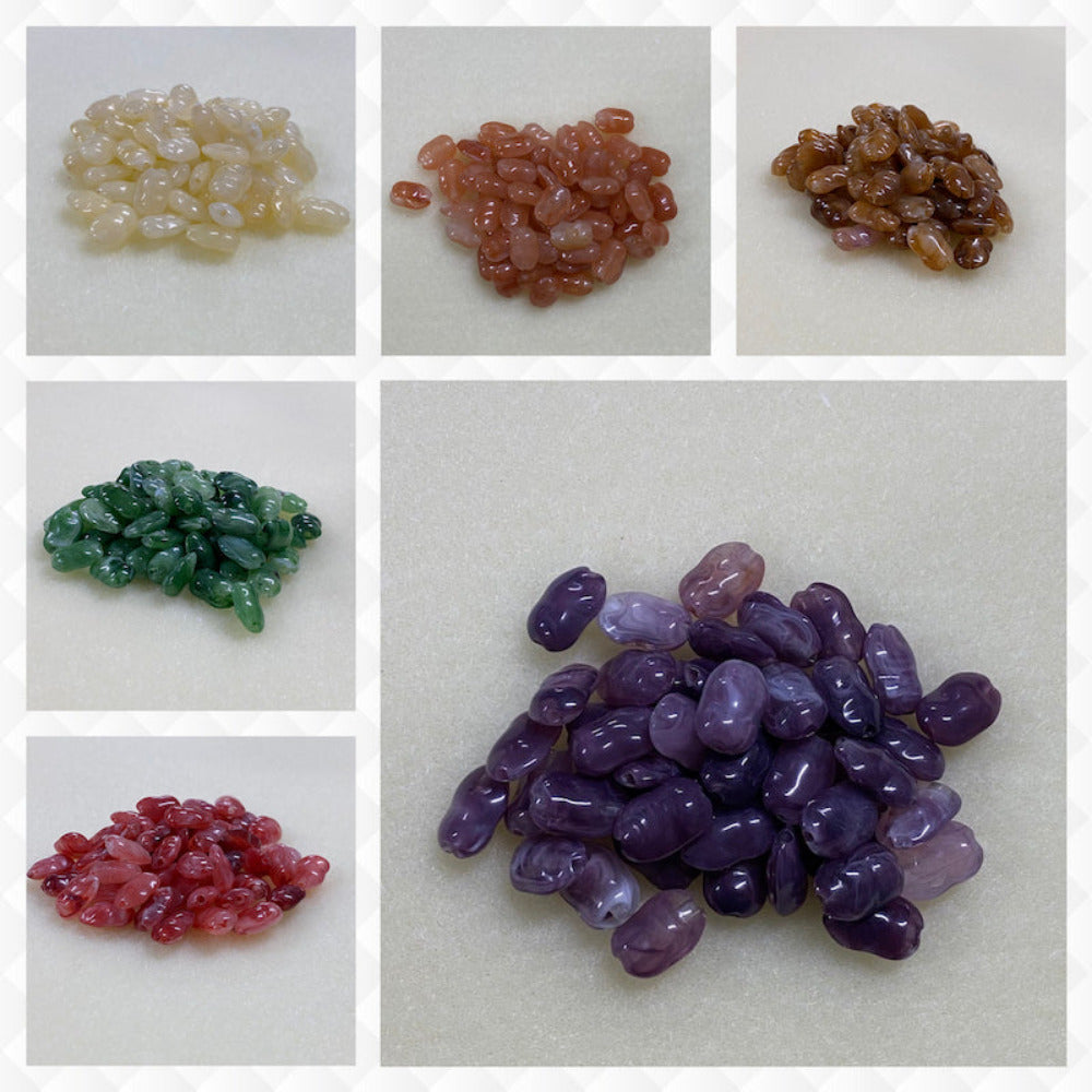 A collage of six different colours of the same gemstone look style bead in small groups on a cream background