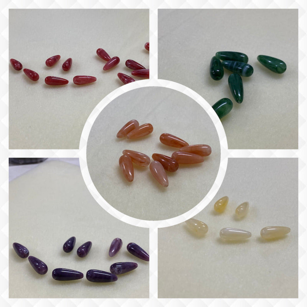 A collage of five different colours of the same gemstone look style bead in small groups on a cream background