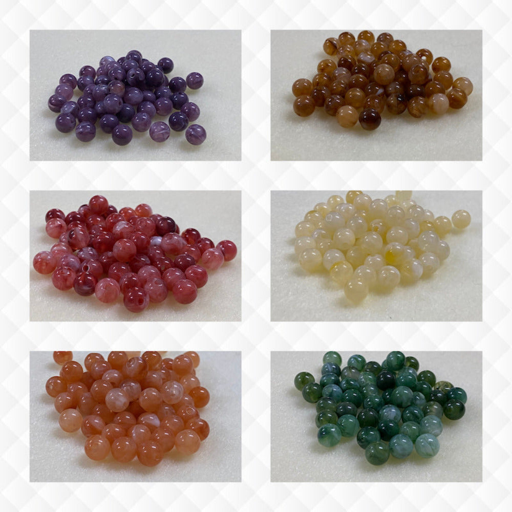 A collage of six different colours of the same gemstone look style bead in small groups on a cream background