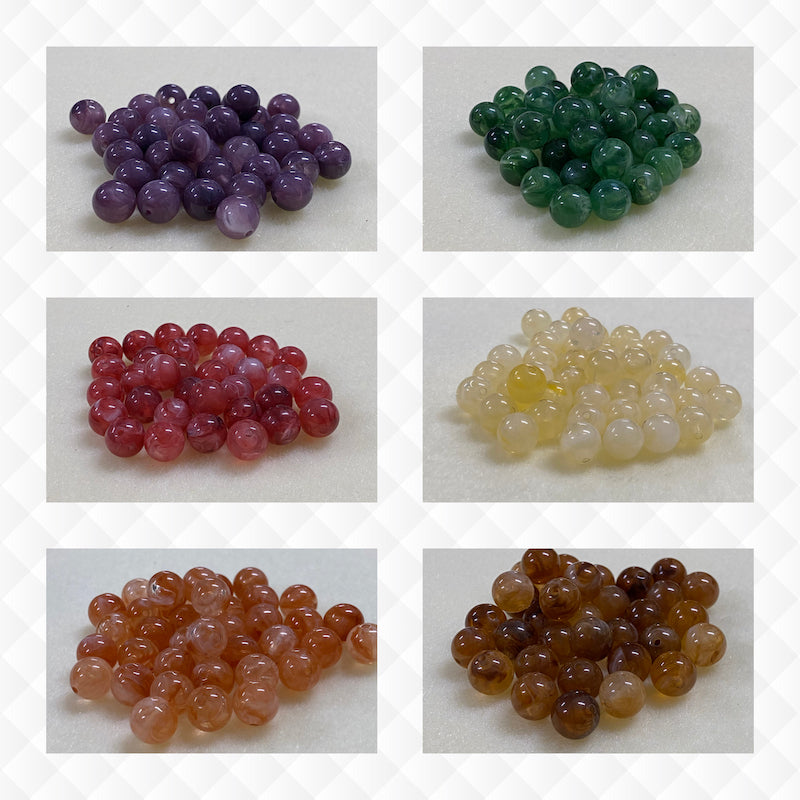 A collage of six different colours of the same gemstone look style bead in small groups on a cream background