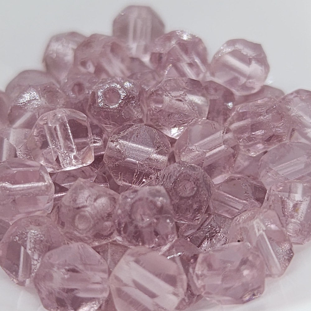 A pile of light amethyst transparent round faceted Czech glass beads