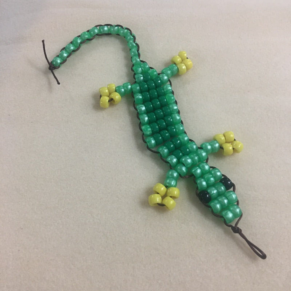 colourful beaded gecko lizard toy made at Bead Shack snakes & lizard birthday party on a beige background